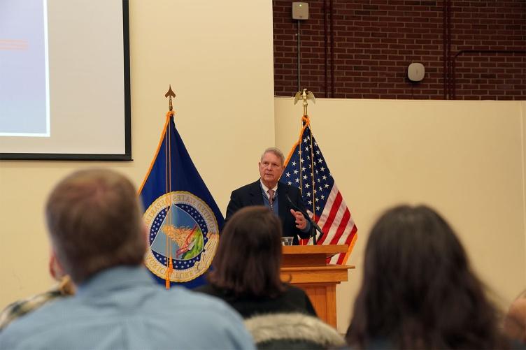 U.S. 1月初举行的市政厅会议上，农业部长汤姆·维尔萨克站在讲台上与主要研究社区成员交谈.